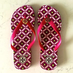 Tory Burch pink pattern flip flops.